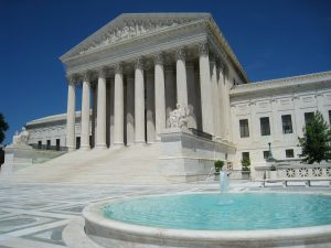 Image of Supreme Court Building in Washington DC and a fountain outside the building